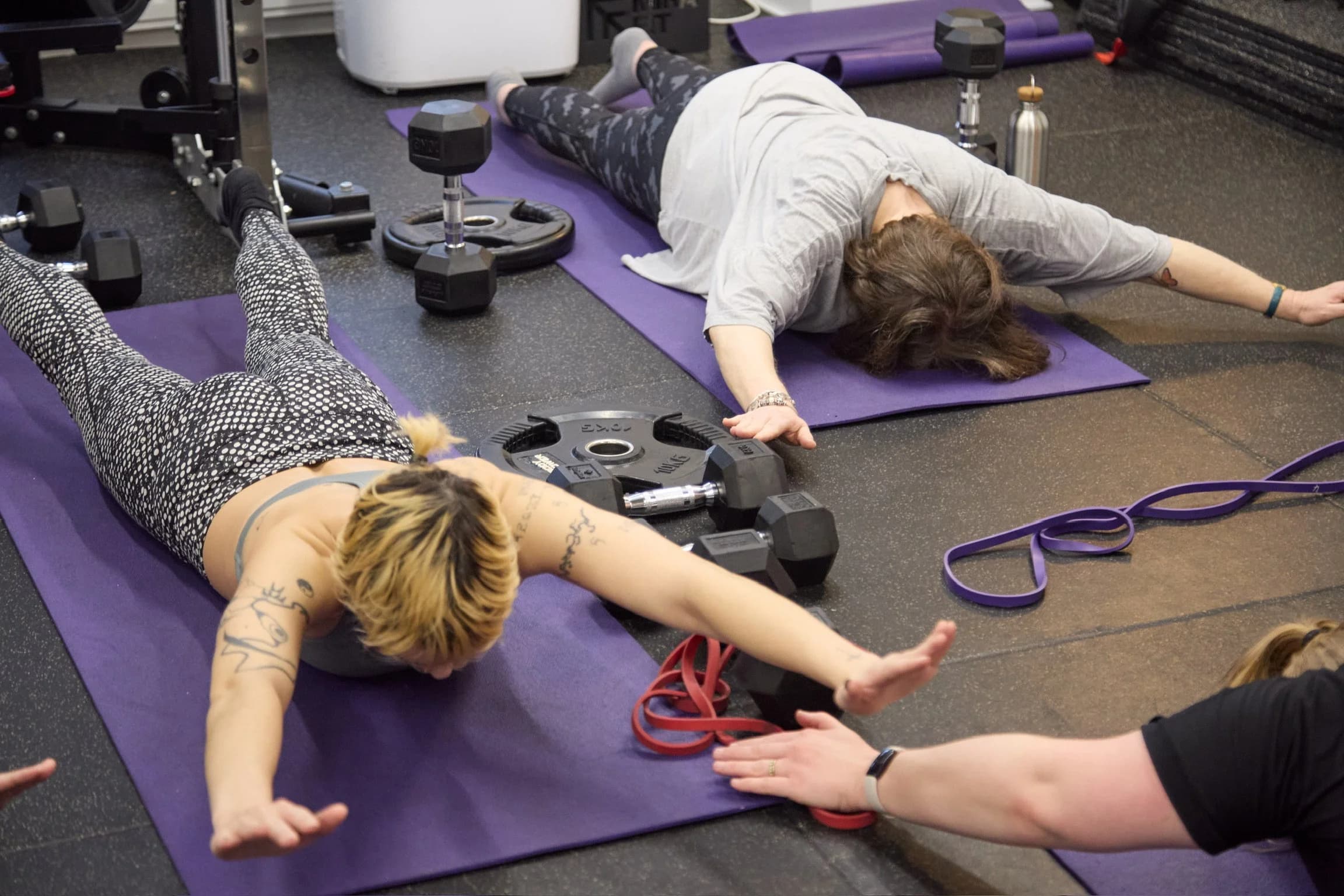 Coach cueing floor-based core work at AW Wellness Studios